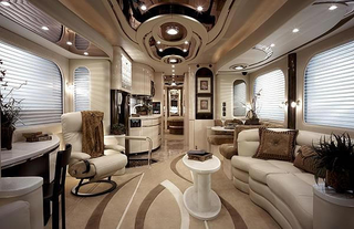 Illustration for article titled Luxury Caravan Has Sports Car Parking Dock In Its Belly